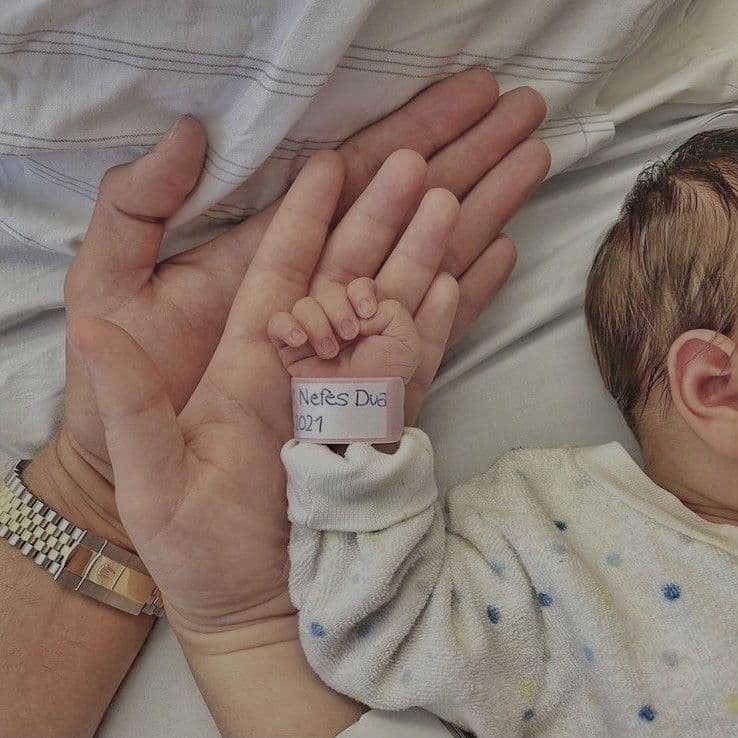 Parent holding newborn baby